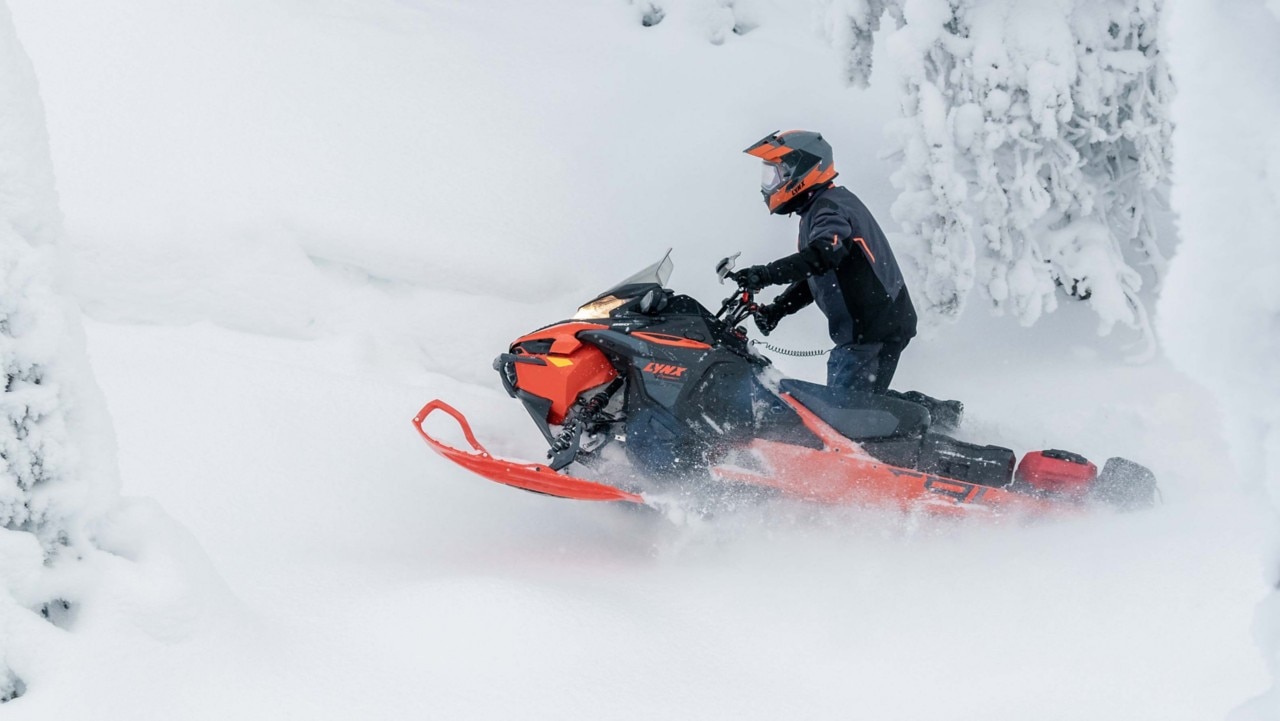 LinQ accessorized Lynx Xterrain Brutal snowmobile riding in deep snow