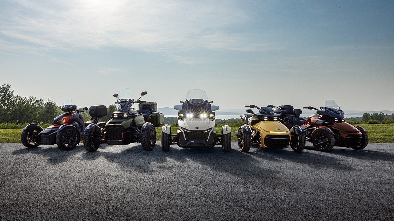 Several new 2026 Can-Am 3-wheel models placed next to each other in front of a field
