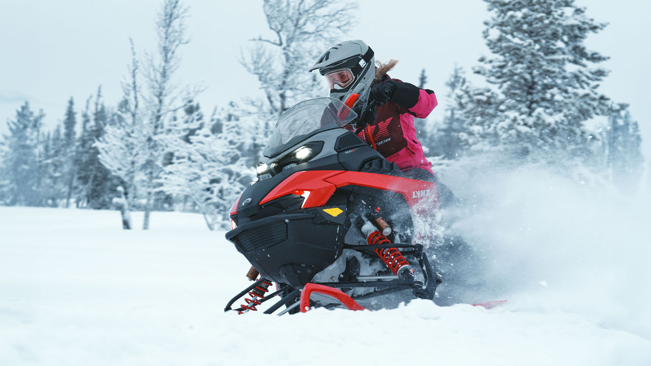 Lynx Rave RE 2026 snowmobile cornering on bumpy trail