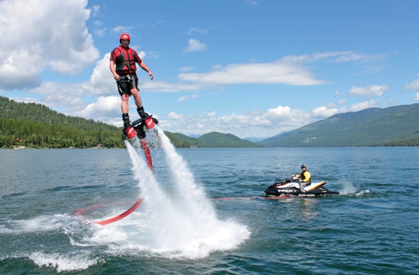 Shawn Finley, left, rides a flyboard on Whitefish Lake. The board is propelled with water from a Jet Ski. Justin Franz | Flathead Beacon. 