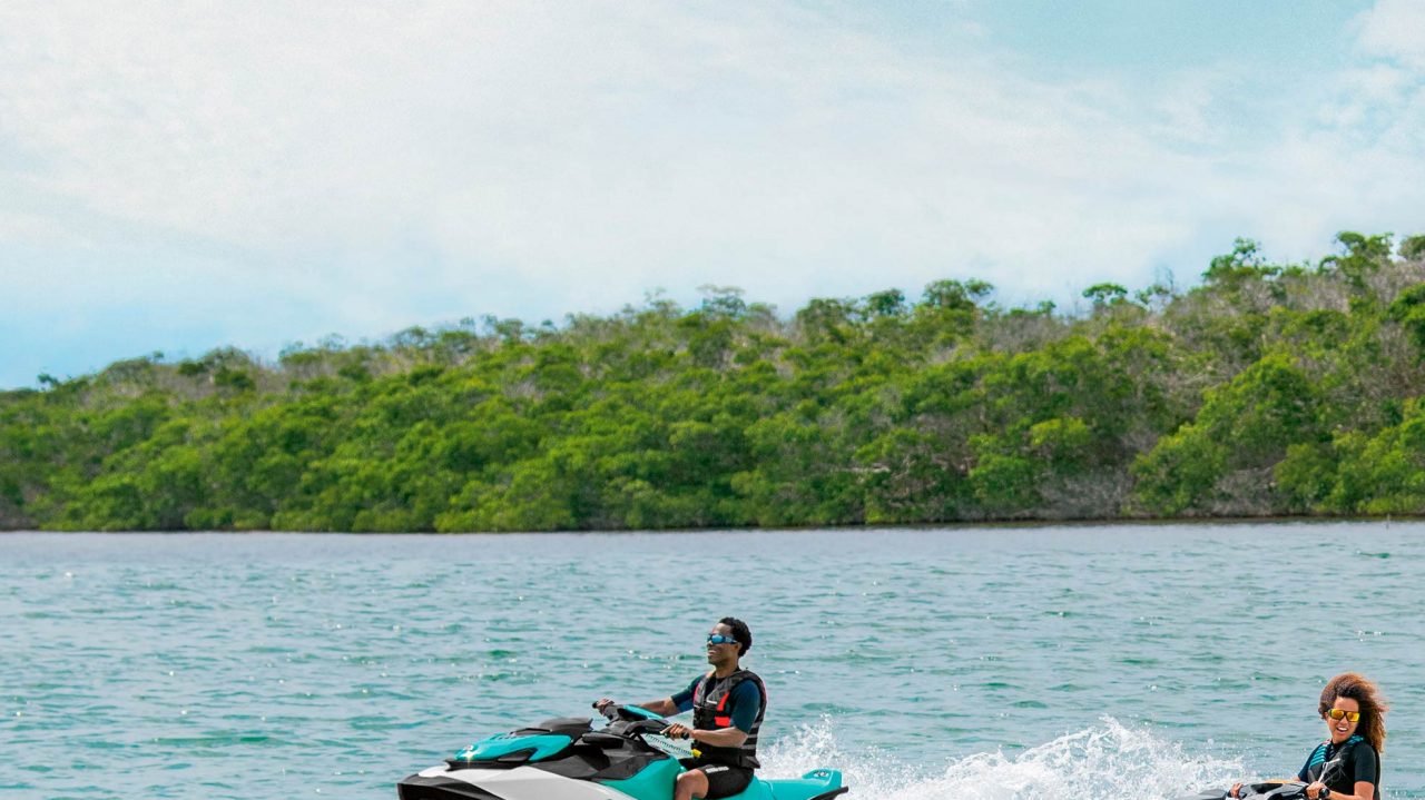 A man and a woman riding a Sea-Doo GTI