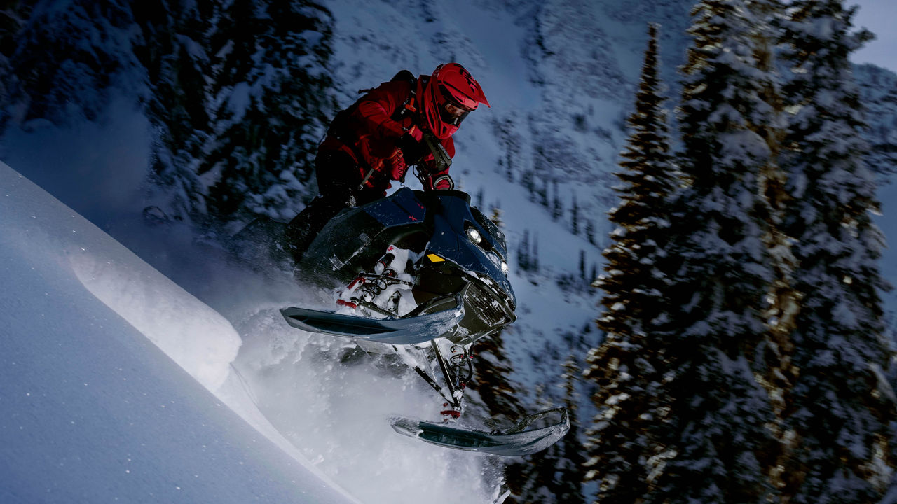 Rider zjeżdżający z góry na skuterze śnieżnym do głębokiego śniegu 2025 Ski-Doo Summit