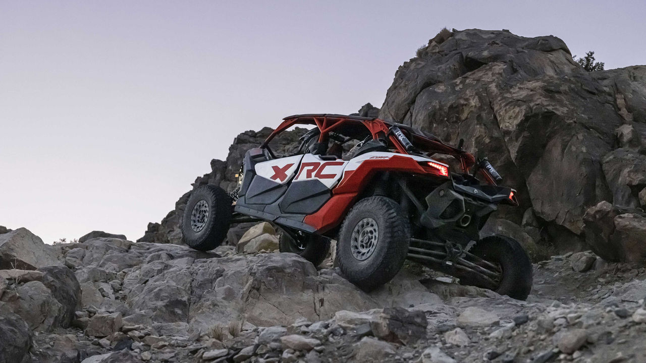 A Can-Am Maverick X3 Max X RC climbing over rocks