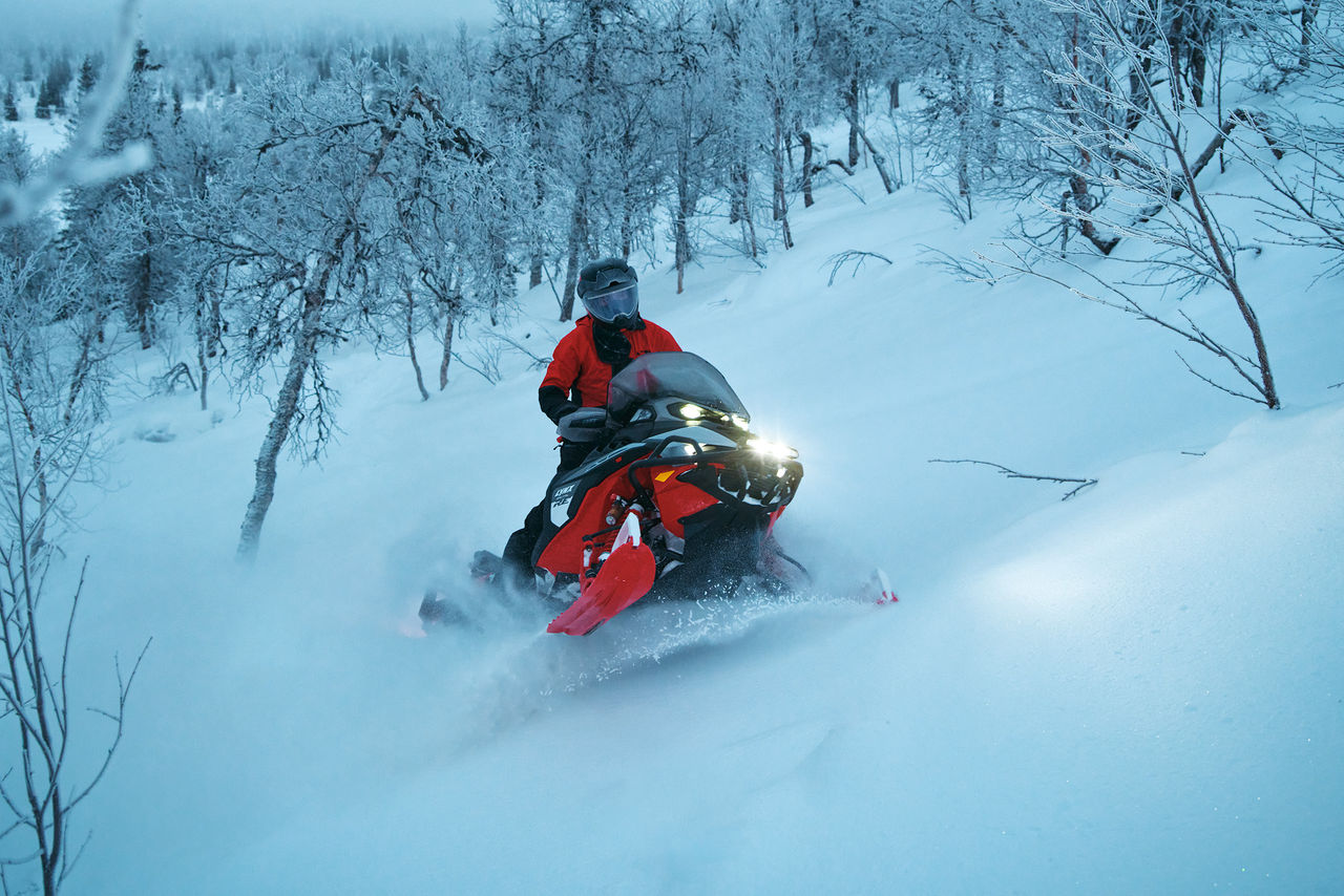 2027 Lynx Brutal RE riding up a snowy hill