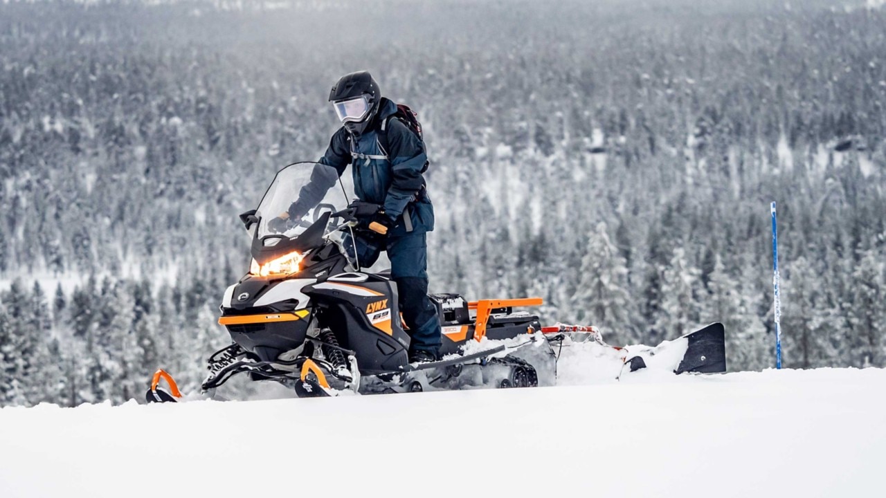 69 Ranger Alpine snowmobile making a trail