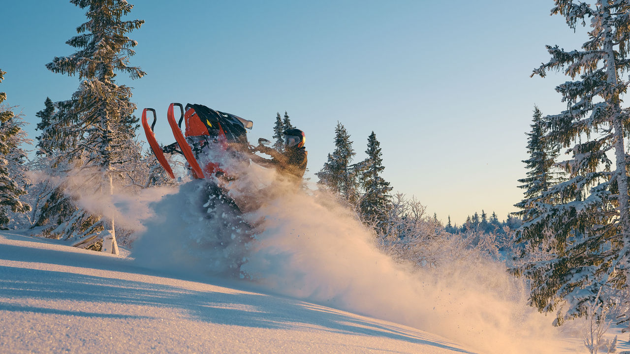 2026 Lynx Brutal RE snowmobile accelerating through a wind lip