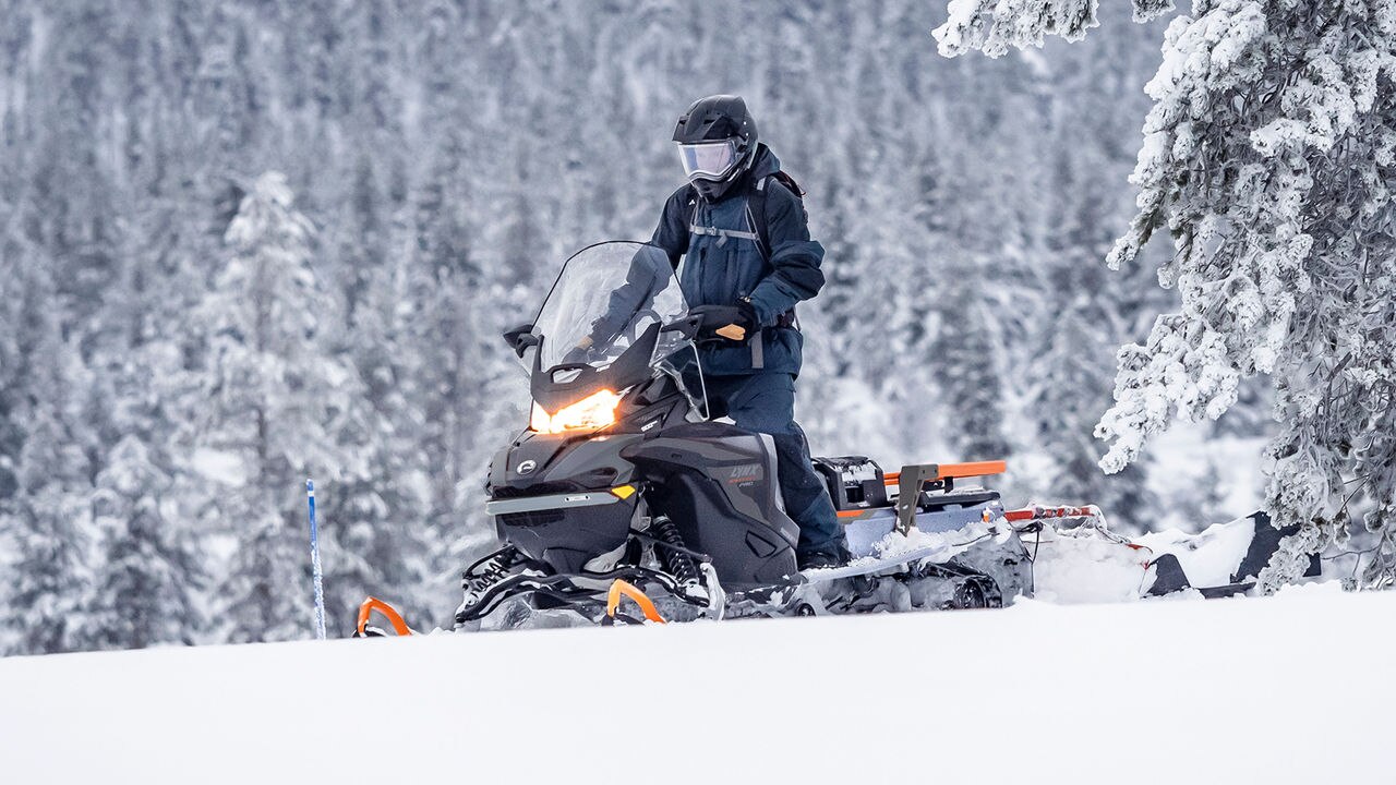 Lynx 69 Ranger PRO 2025 snowmobile towing a trail plow on fell