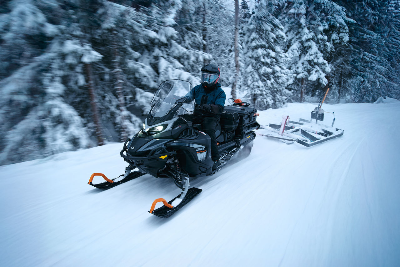 Снегоход Lynx 69 Ranger PRO 2027 во время работы в заснеженном лесу