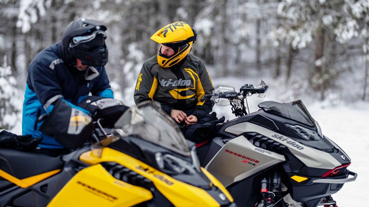 2 riders before a snowmobile ride with their 2023 Ski-Doo Renegade