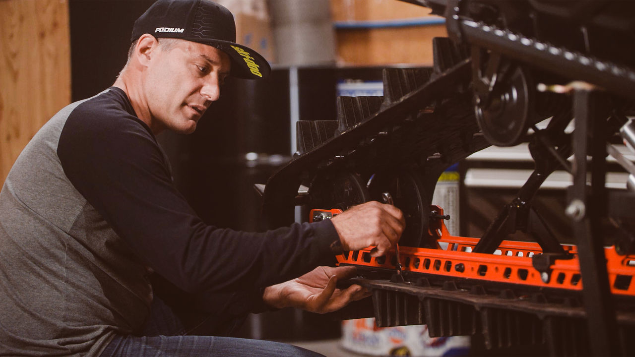 Ski-Doo Ambassador Carl Kuster doing maintenance on his Ski-Doo snowmobile