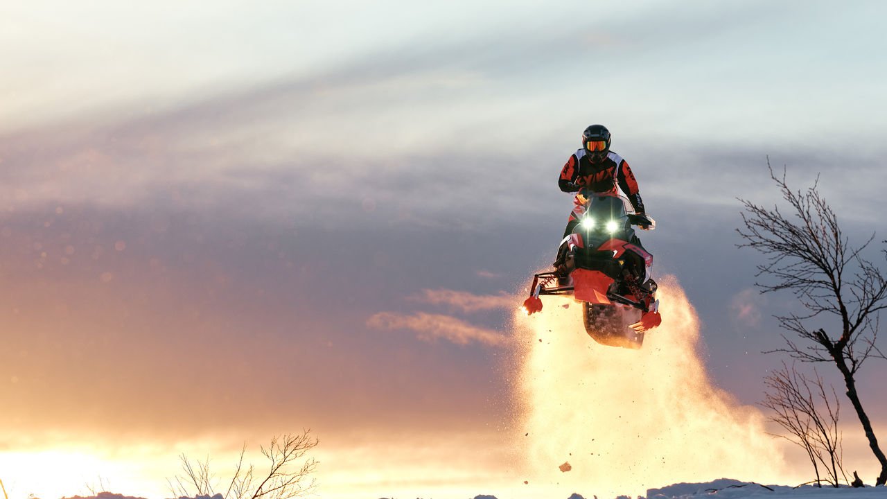 Rider performing a high jump on a 2027 Lynx Rave RE snowmobile