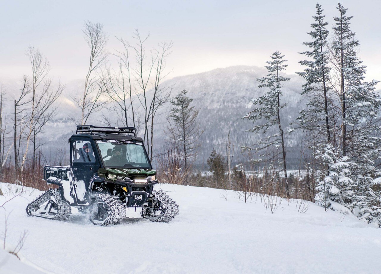 Can-Am Off-Road Side-by-Side Vehicle Defender CAB in a forest during winter