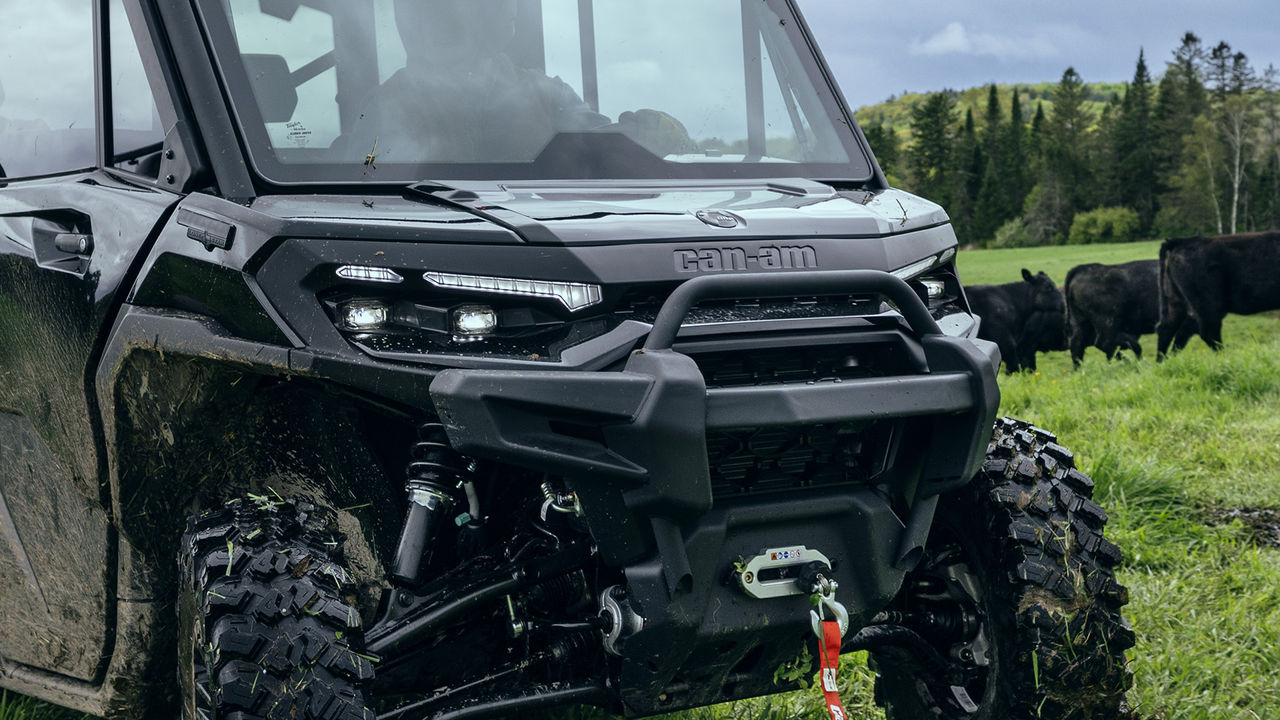Rider reaching for a LinQ storage box in the back of his 2024 Can-Am Maverick R SxS