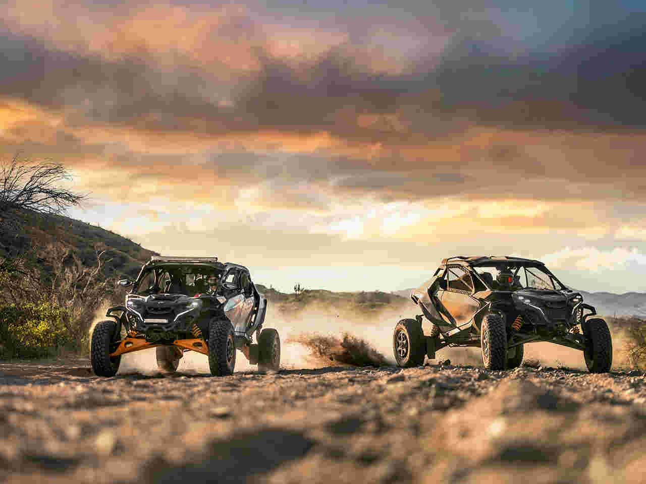 Two Can-Am Maverick SxS riding in the desert