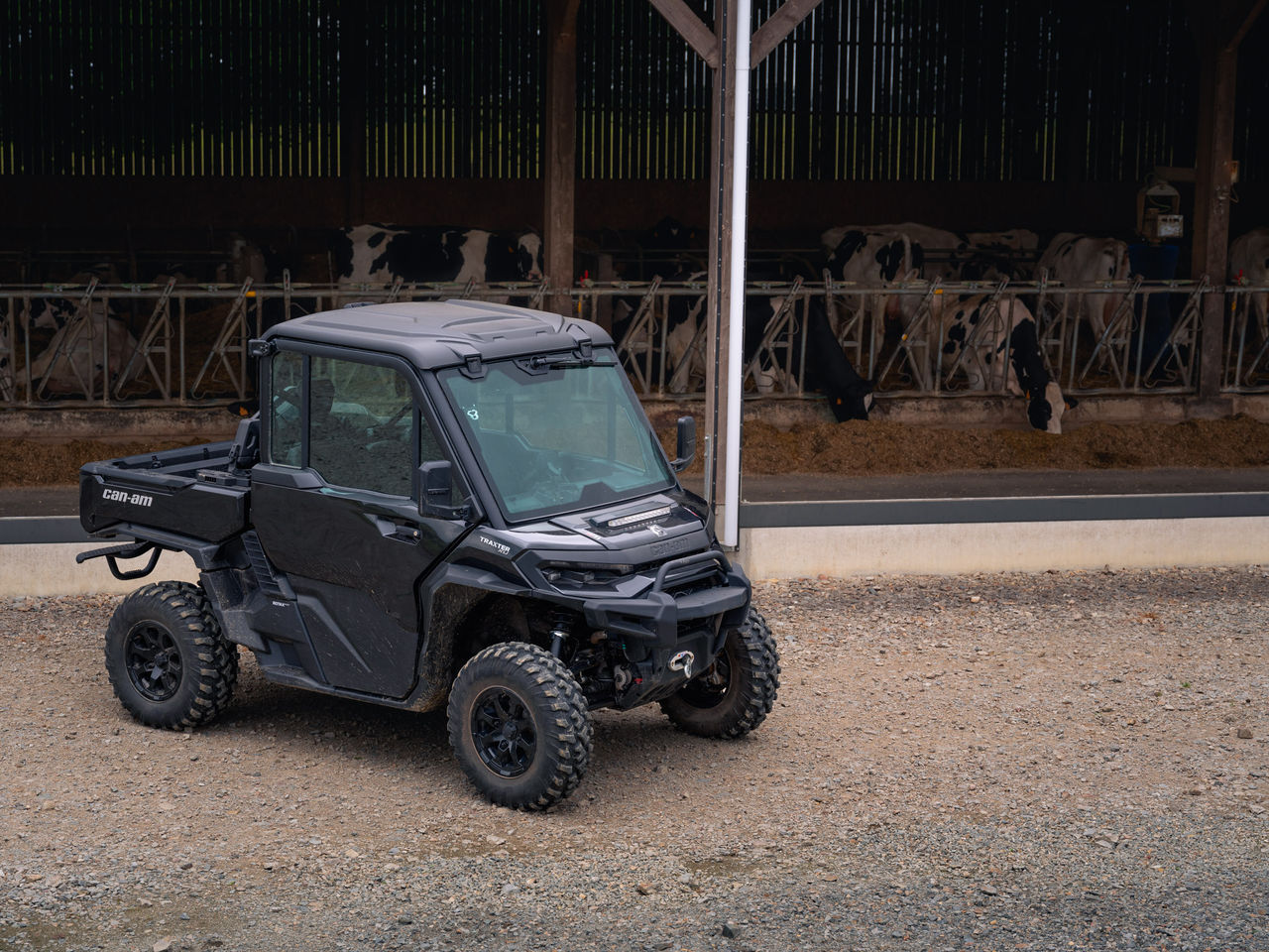 Can-Am Traxter XU HD11 parked next to a feedlot on a farm