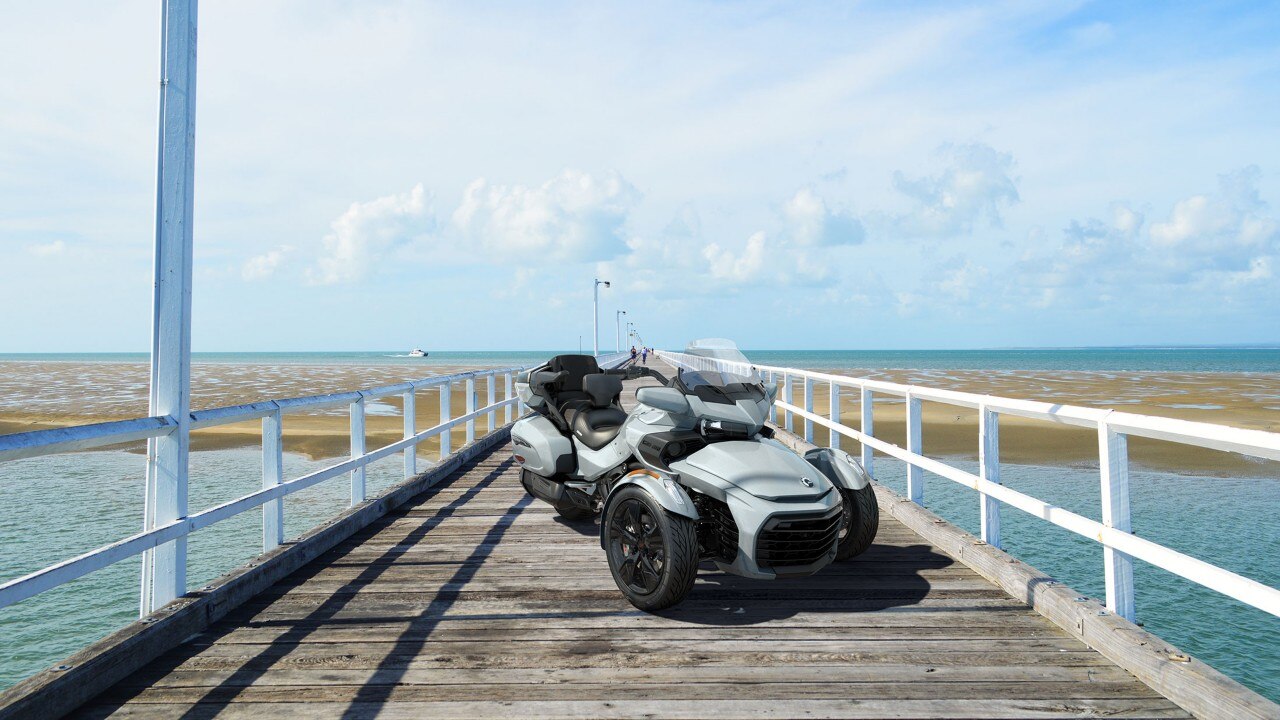 A man driving his Spyder F3 on a road
