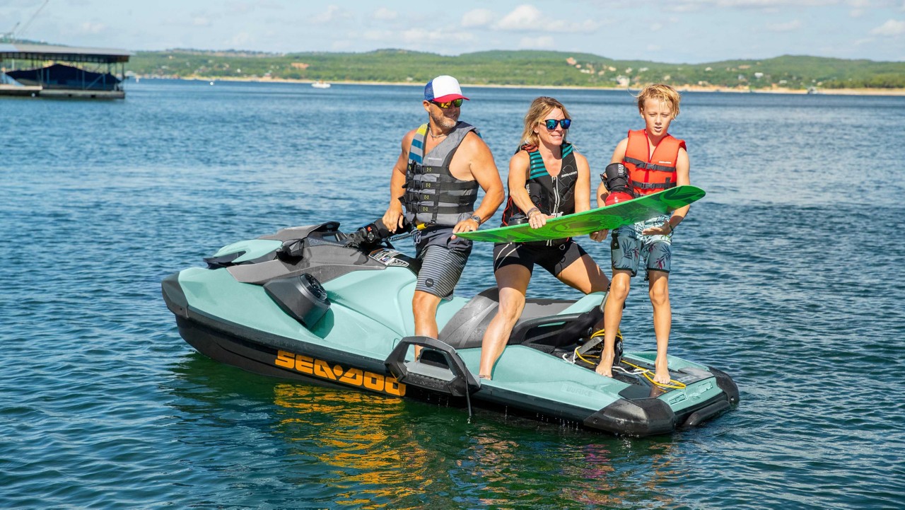 Kid standing on the rear platform of the Sea-Doo Wake