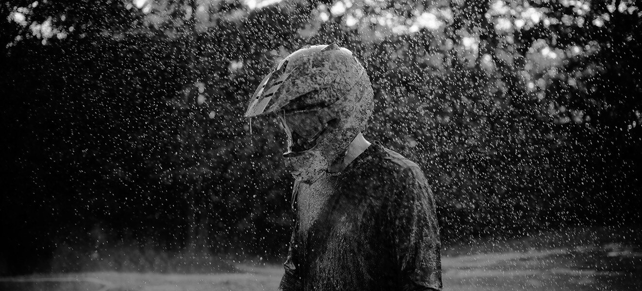 Driver with helmet walking through heavy rain