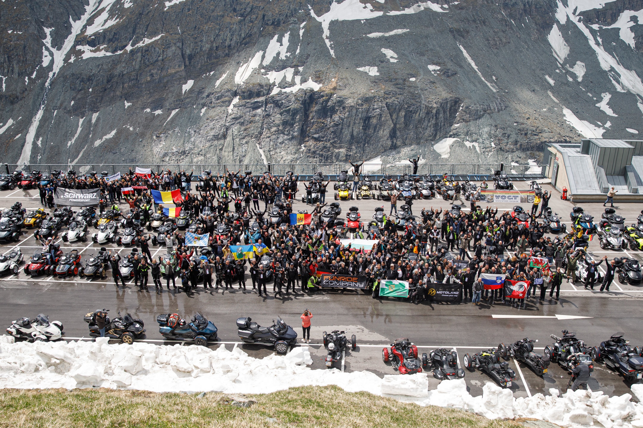 Several women with their arms in the air, proud to be riding Can-Am three-wheelers