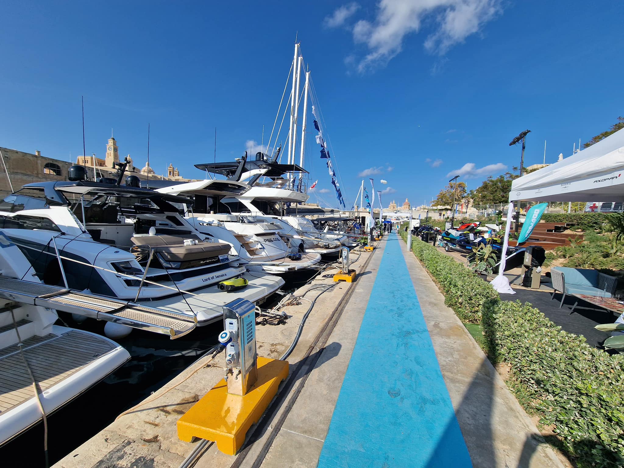 Yachts and Sea-Doo lineup with blue pathway at Malta Boat Show 2024