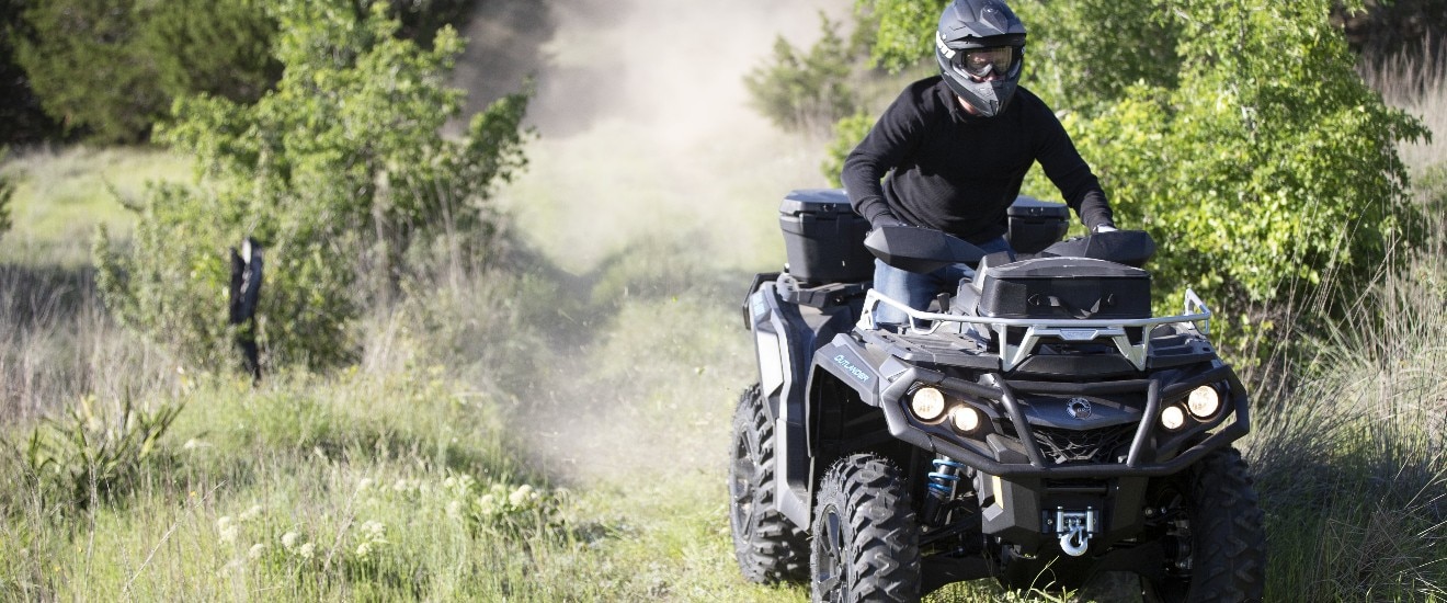 Man driving an outlander in a forest trail