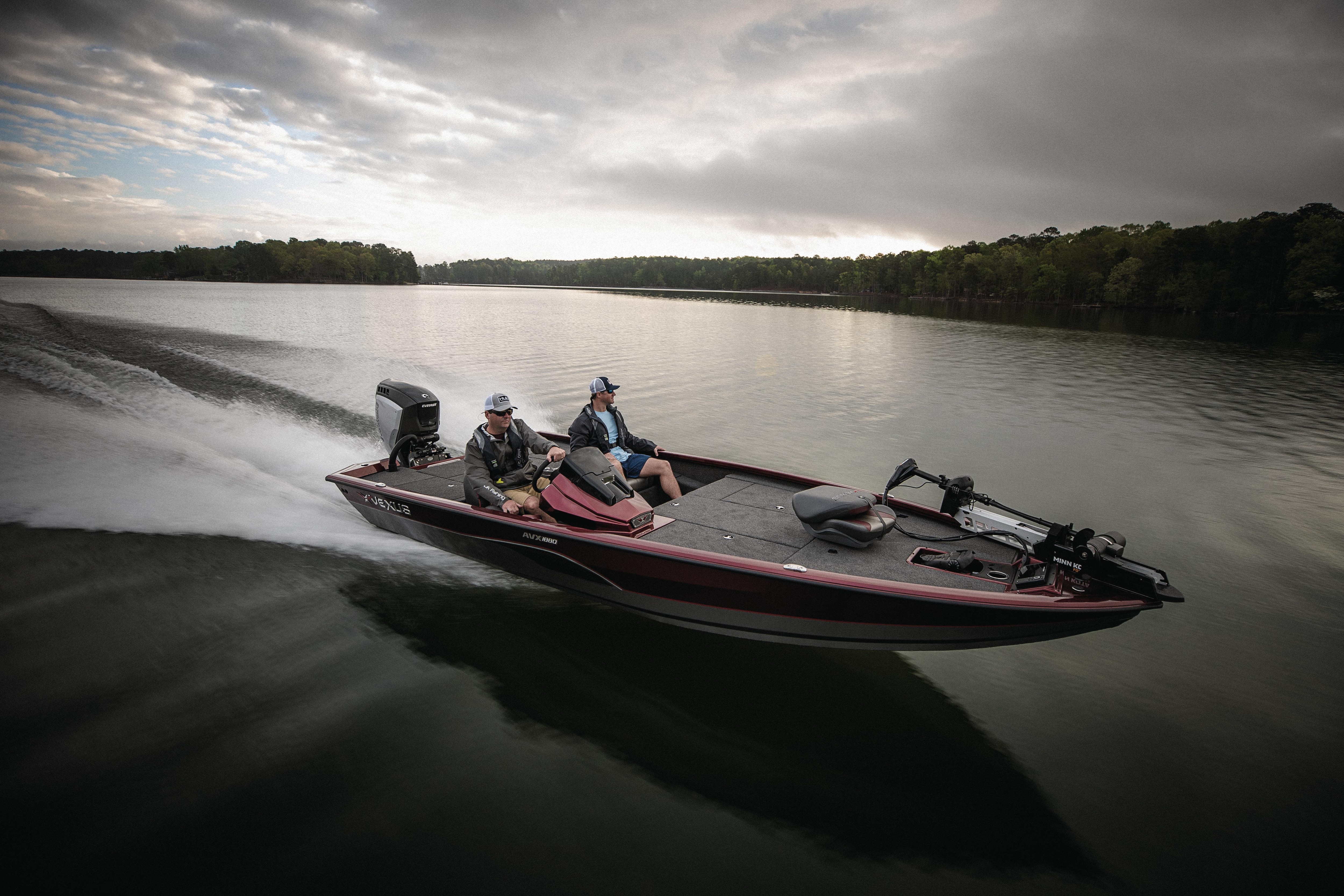 Two men driving a boat yielding an Evinrude motor