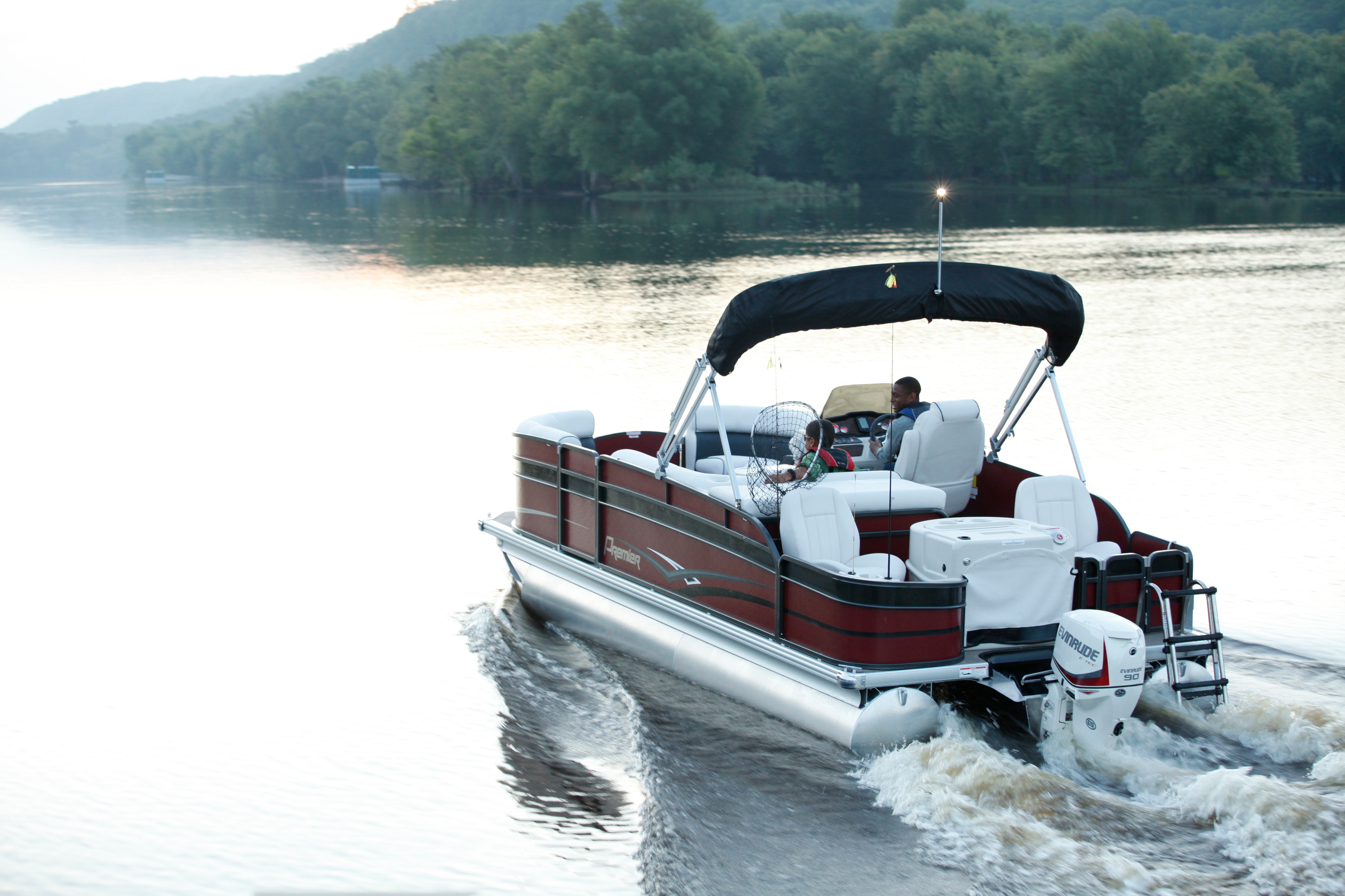 Family driving a pontoon to go fishing 