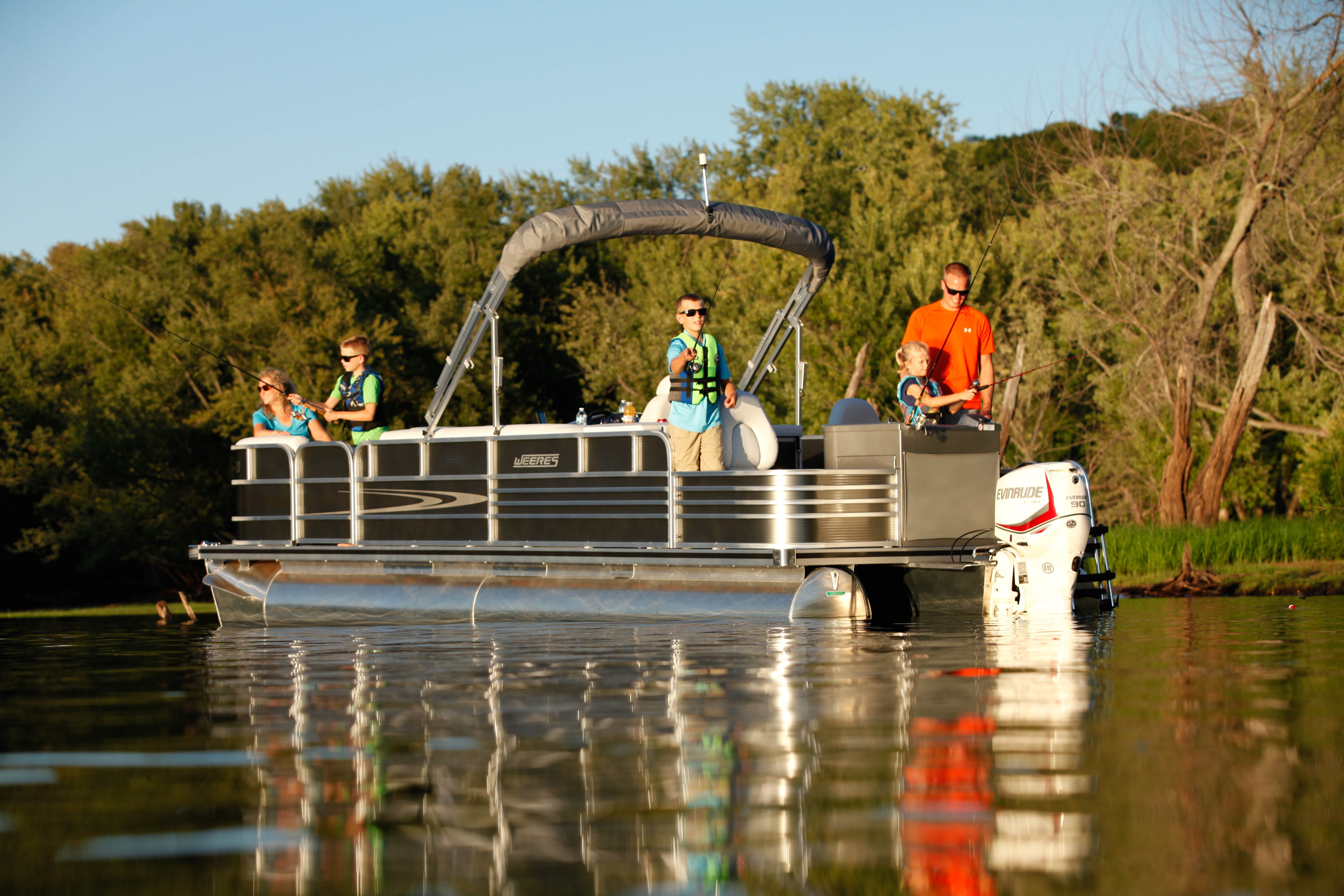 Family fishing out of their pontoon boat