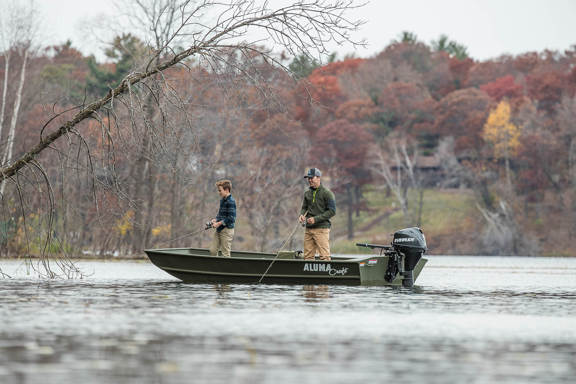 Family fishing while standing up on a boat 