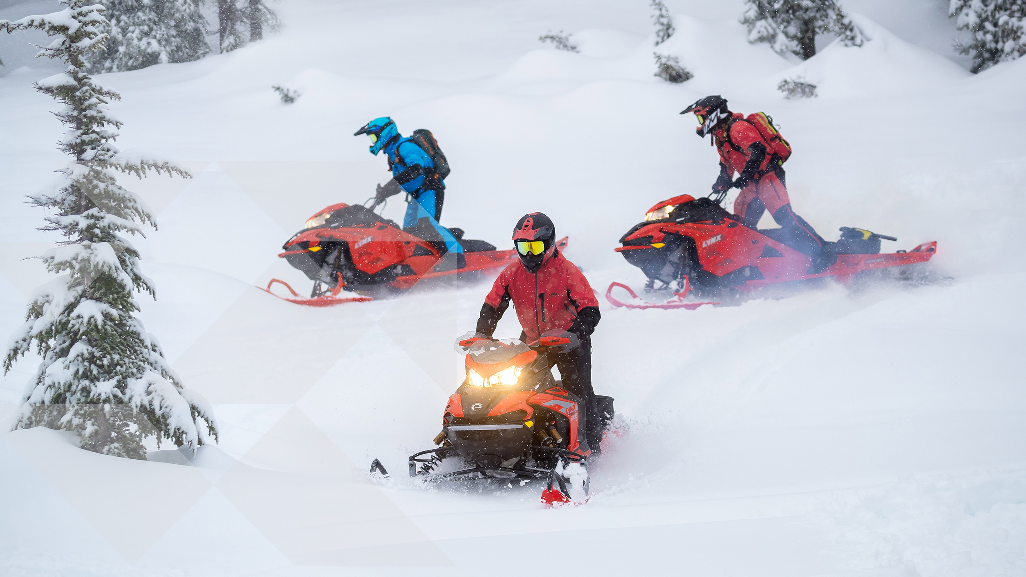 3 people riding Lynx snowmobiles