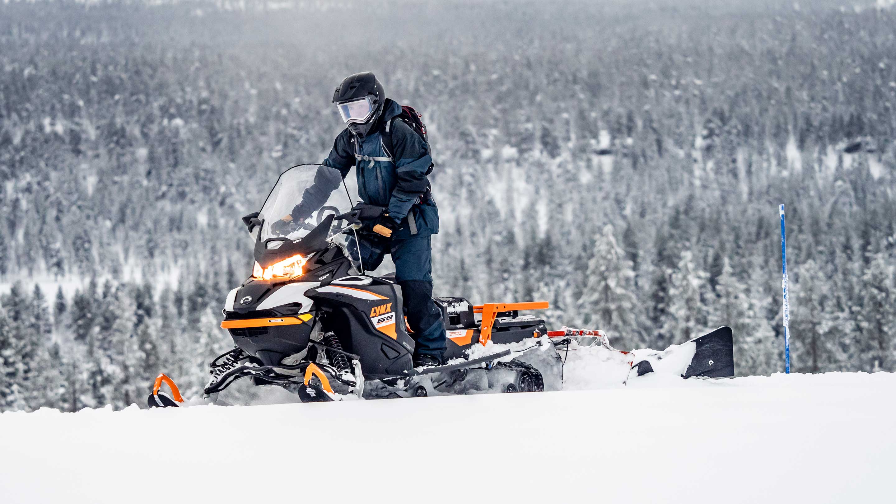 69 Ranger Alpine snowmobile making a trail