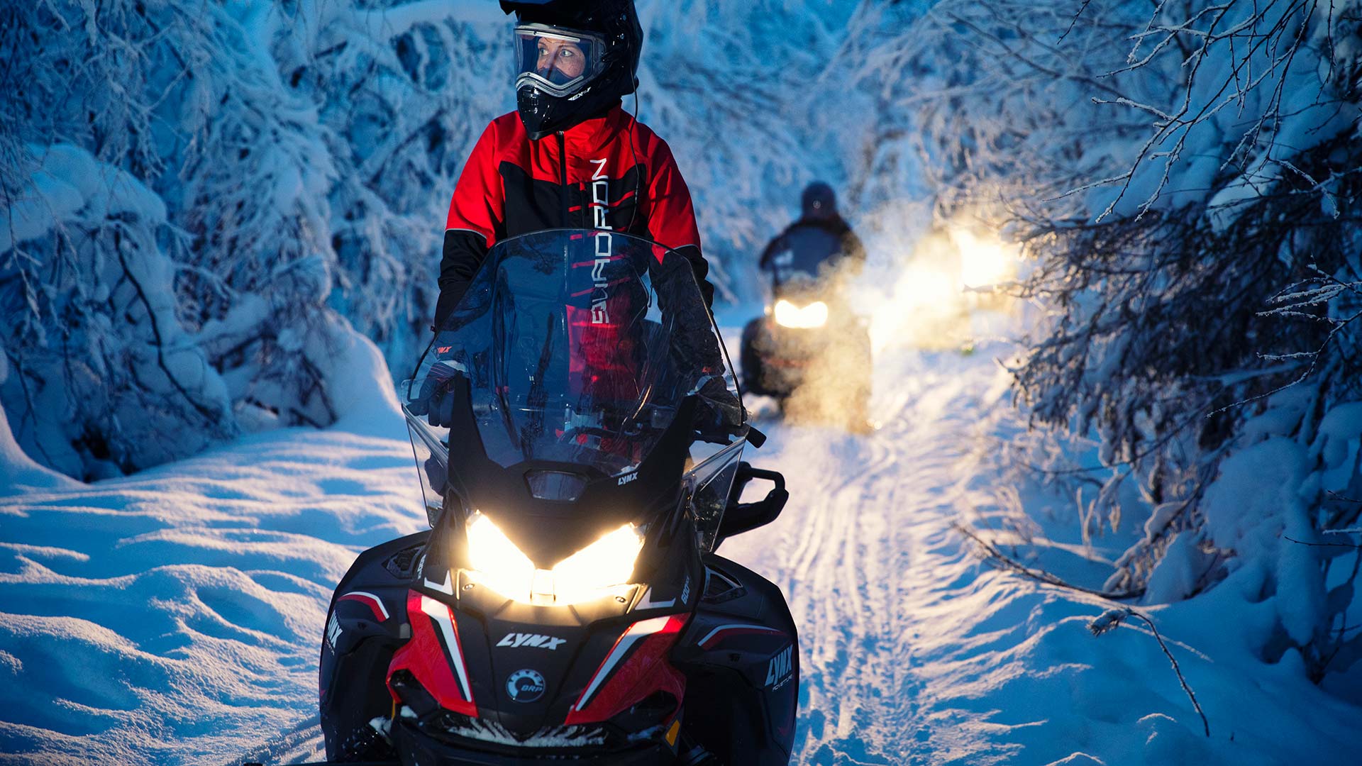 Lynx Adventure snowmobile riding in snowy forest