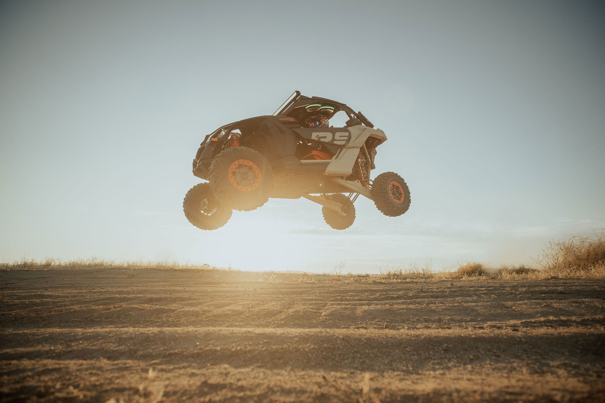 Man driving a Can-Am Maverick in the sand