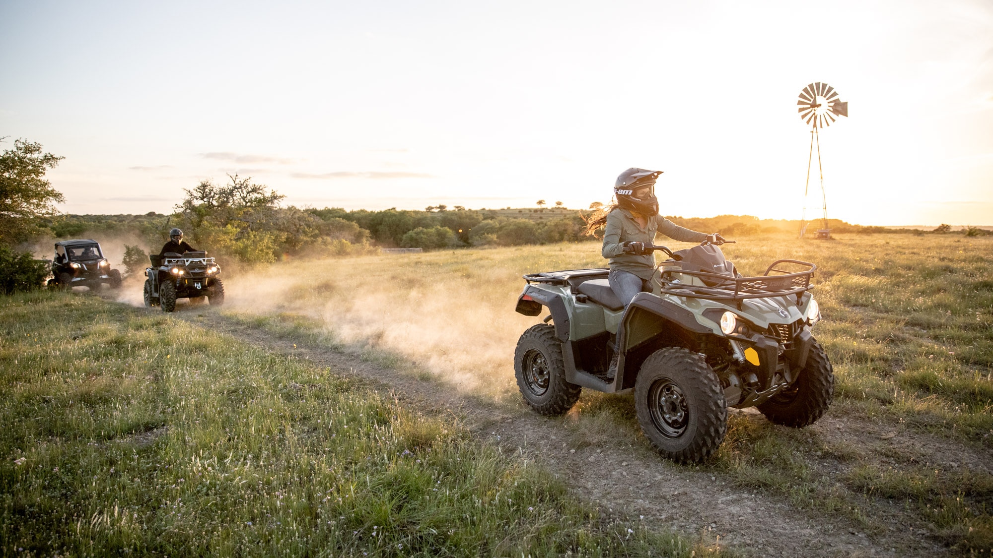 Group driving their All-terrain-vehicle through an open field