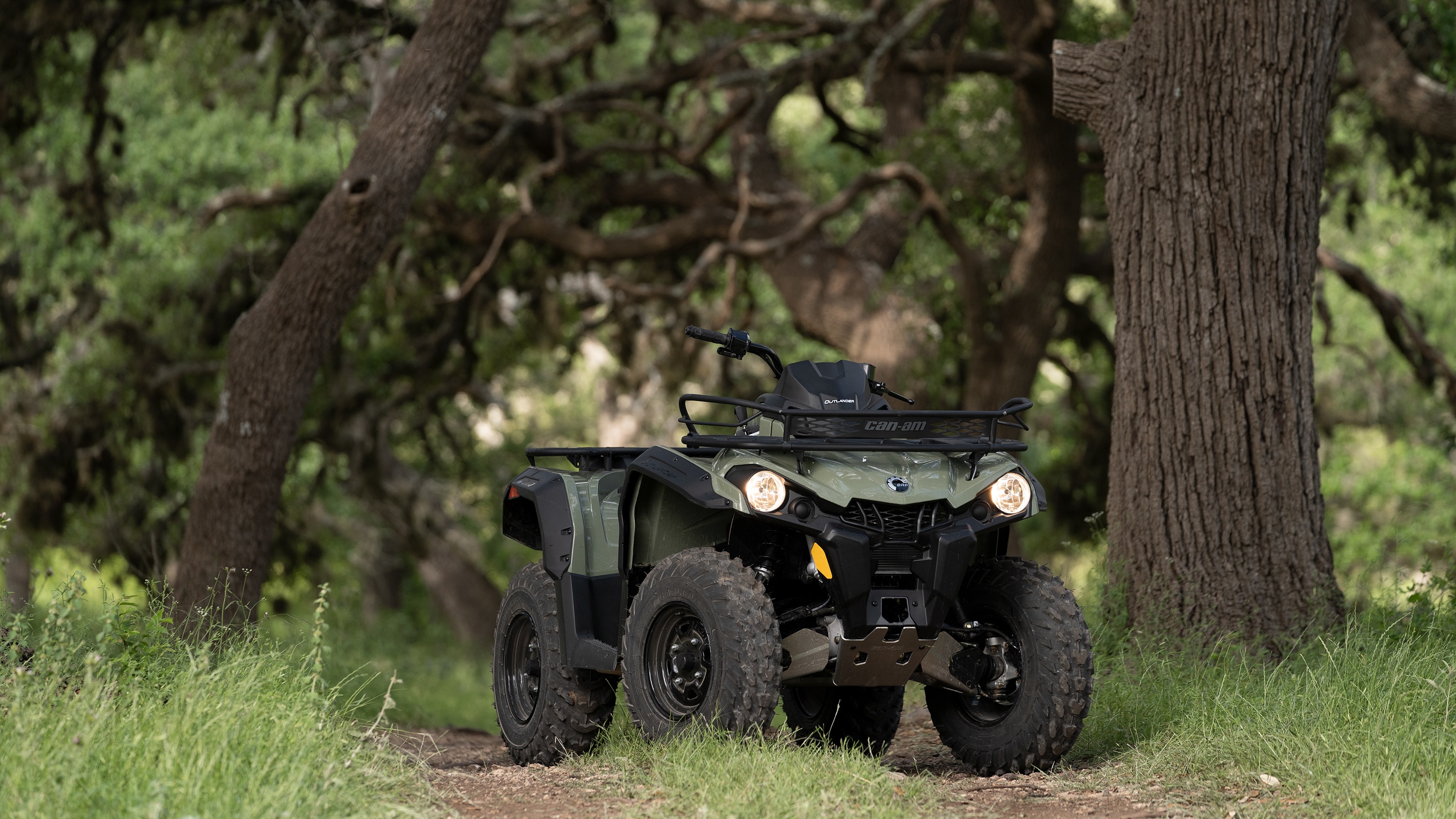 An Outlander 450/570 parked in a forest trail