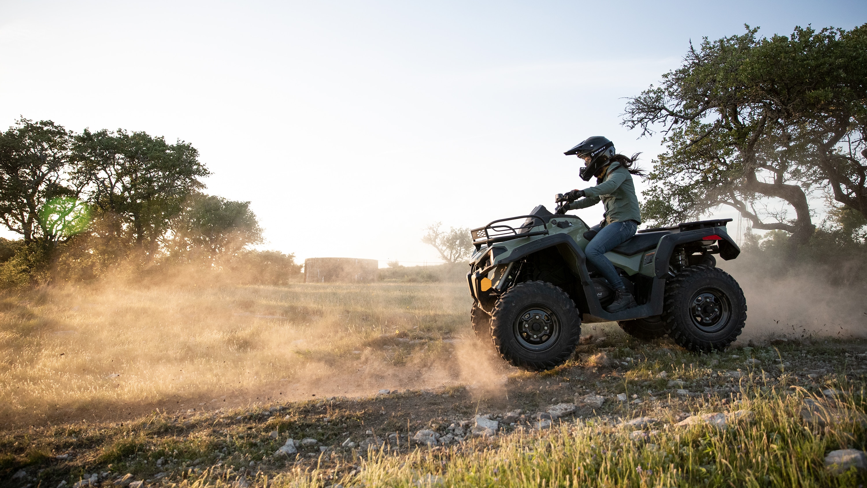 Woman going down a small hill in her Outlander ATV