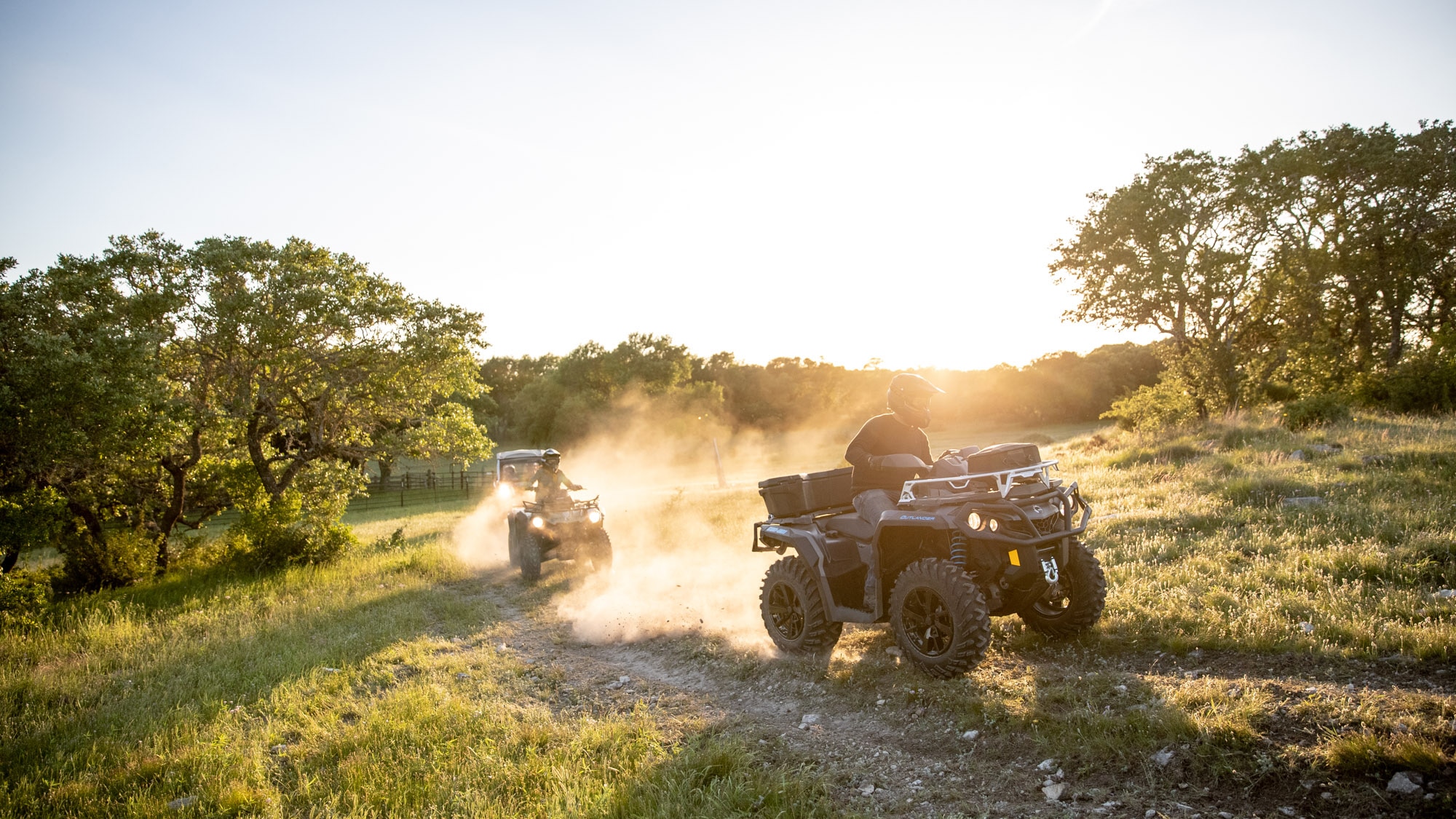 Group driving their All-terrain-vehicle through an open field