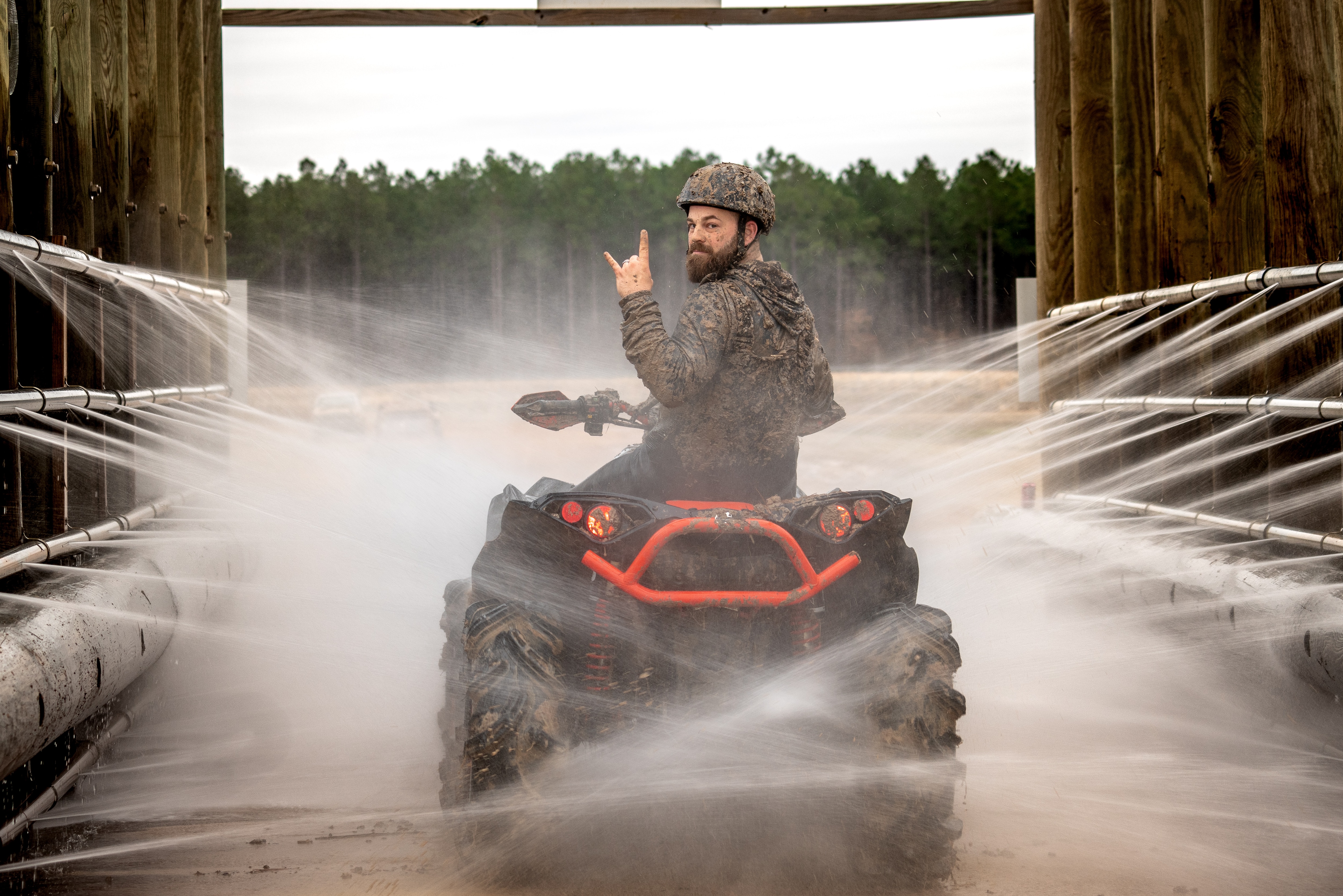 Man cleaning up his ATV with an advanced hose system