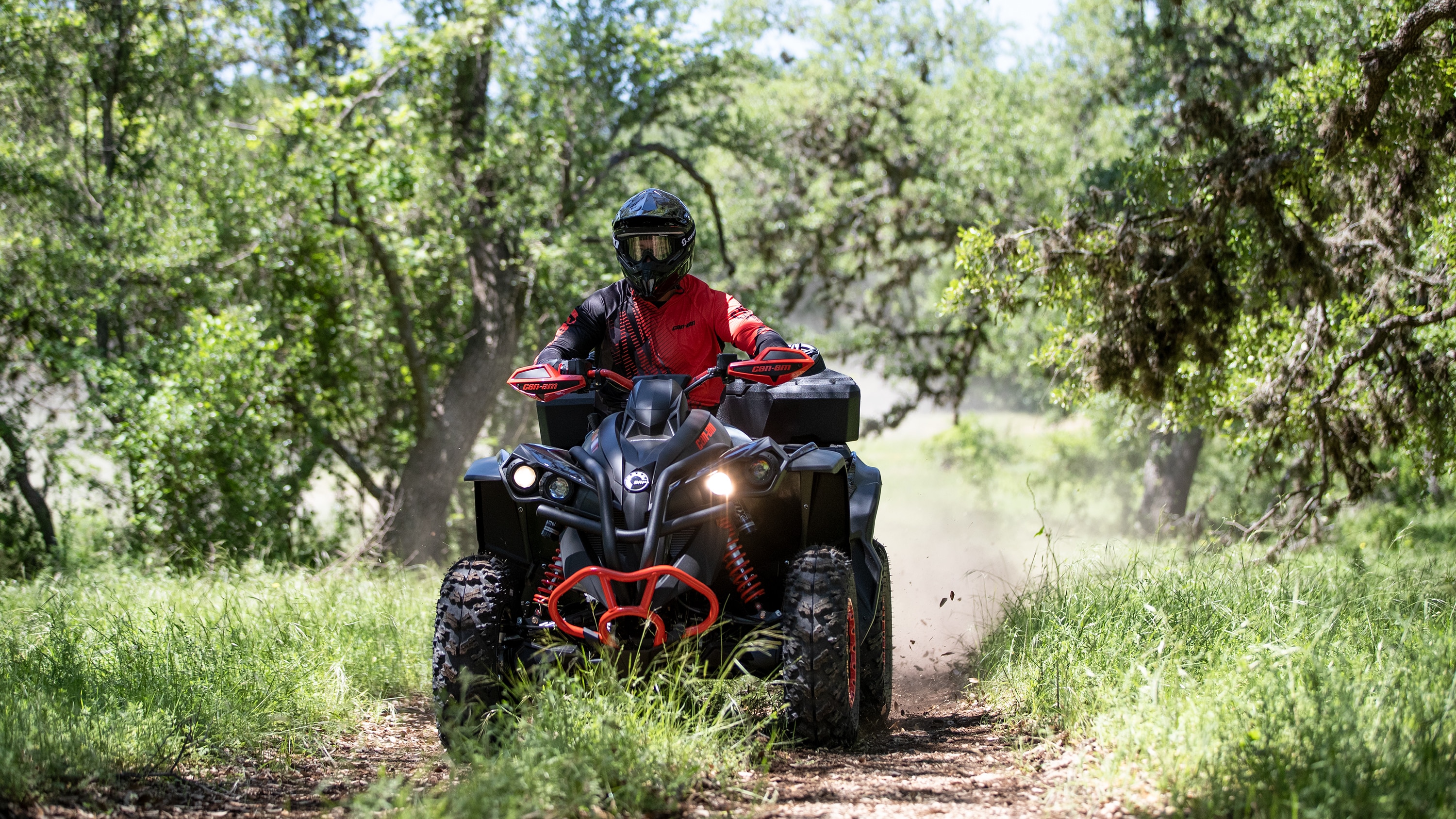 Man going through woodlands with his Renegade ATV