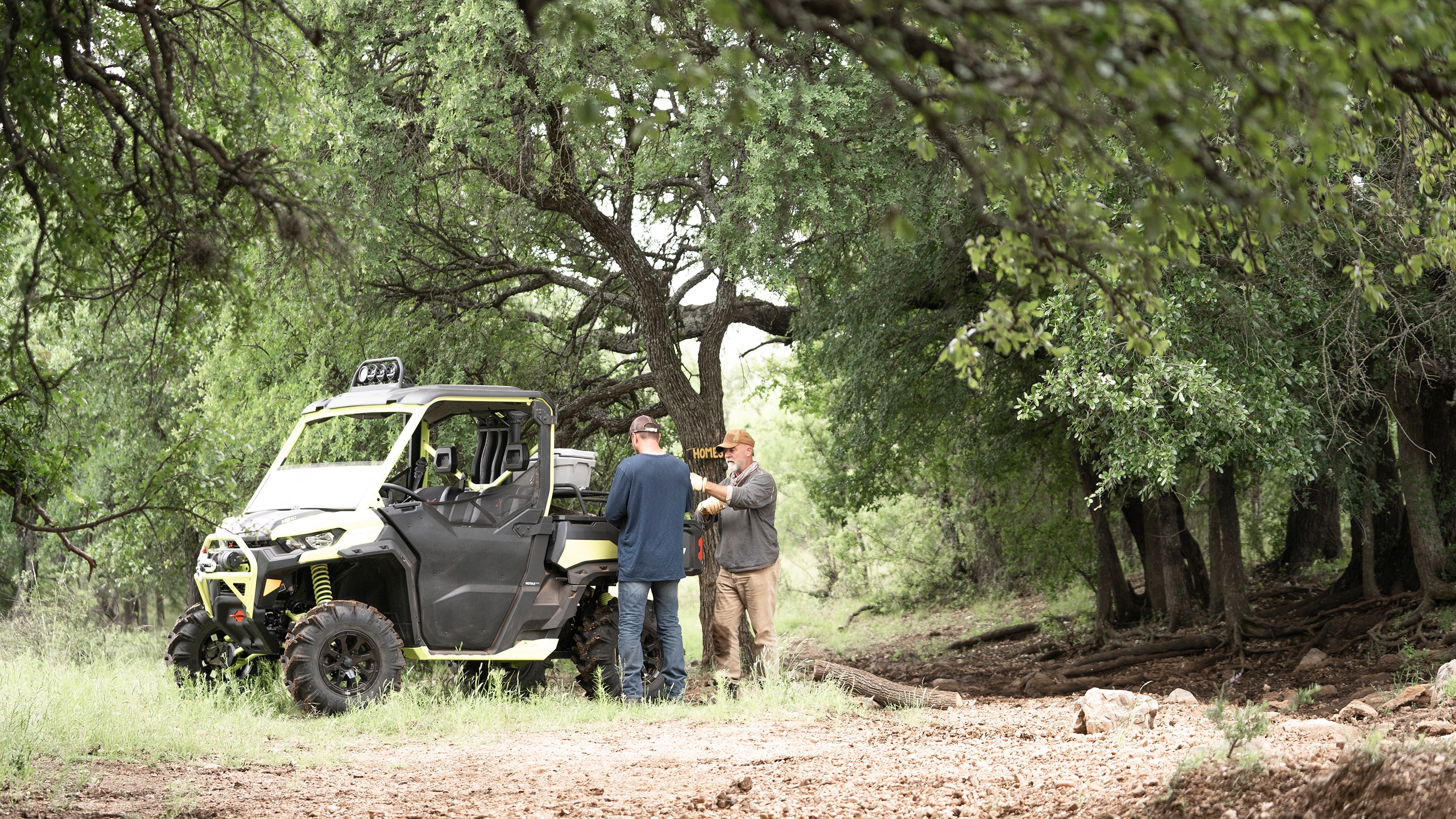 2 Men Looking at the storage on the back of their Traxter vehicle