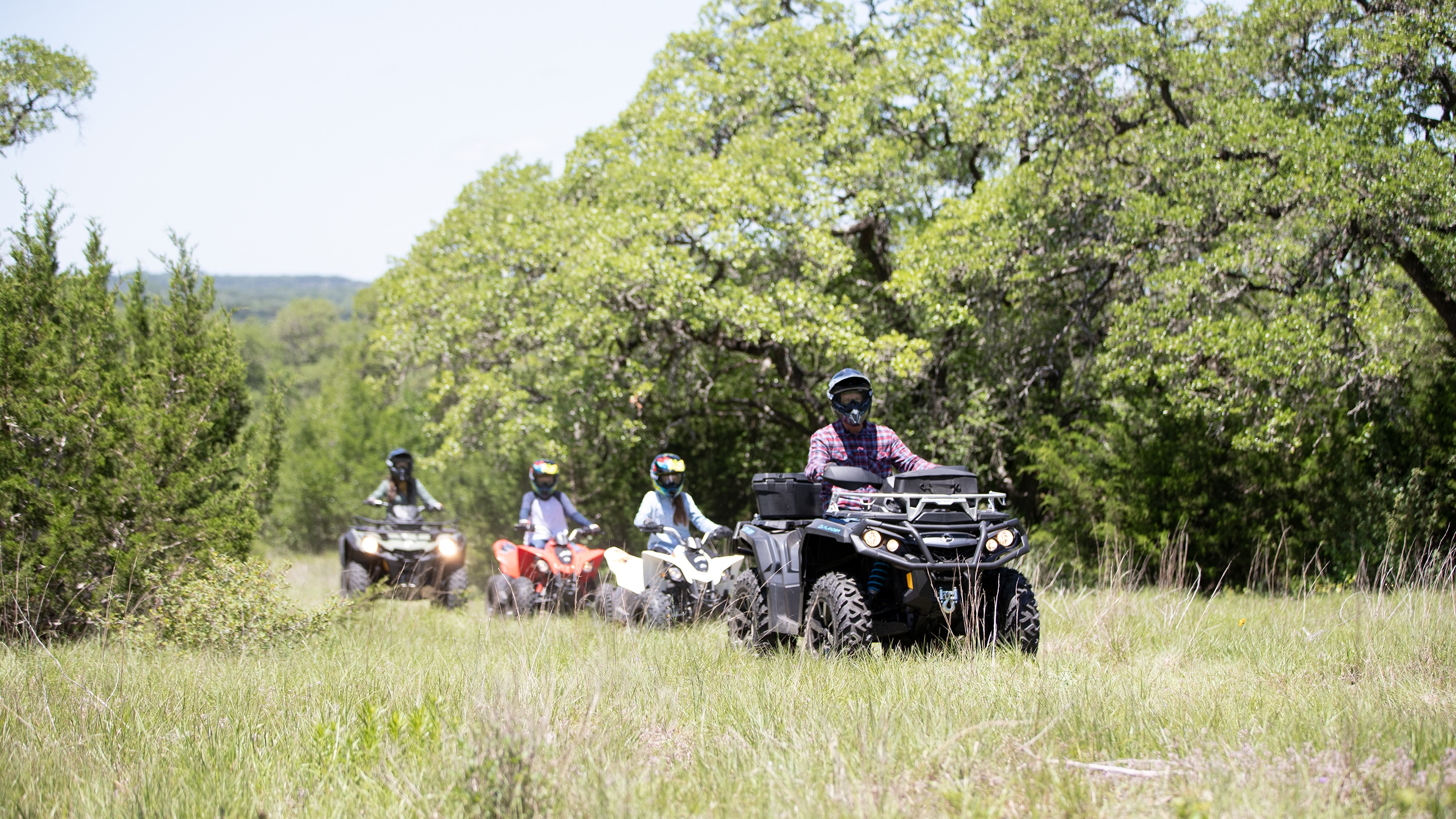 Family driving their ATV in woodlands