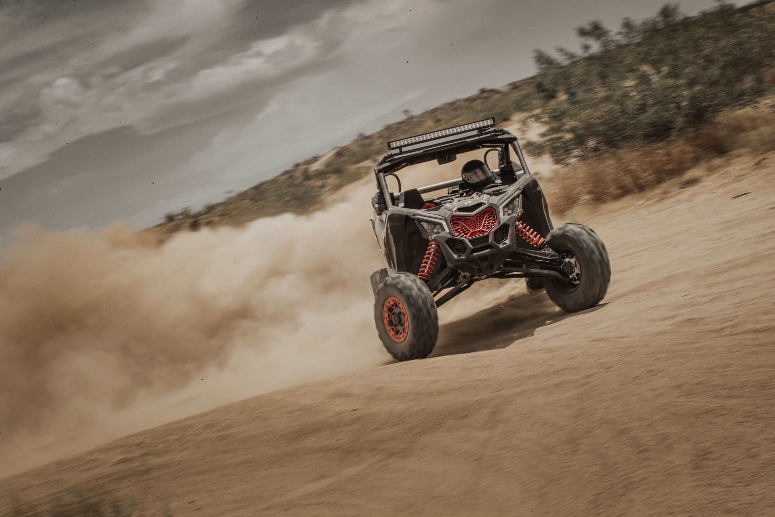 Man driving a Maverick X RS on the sand