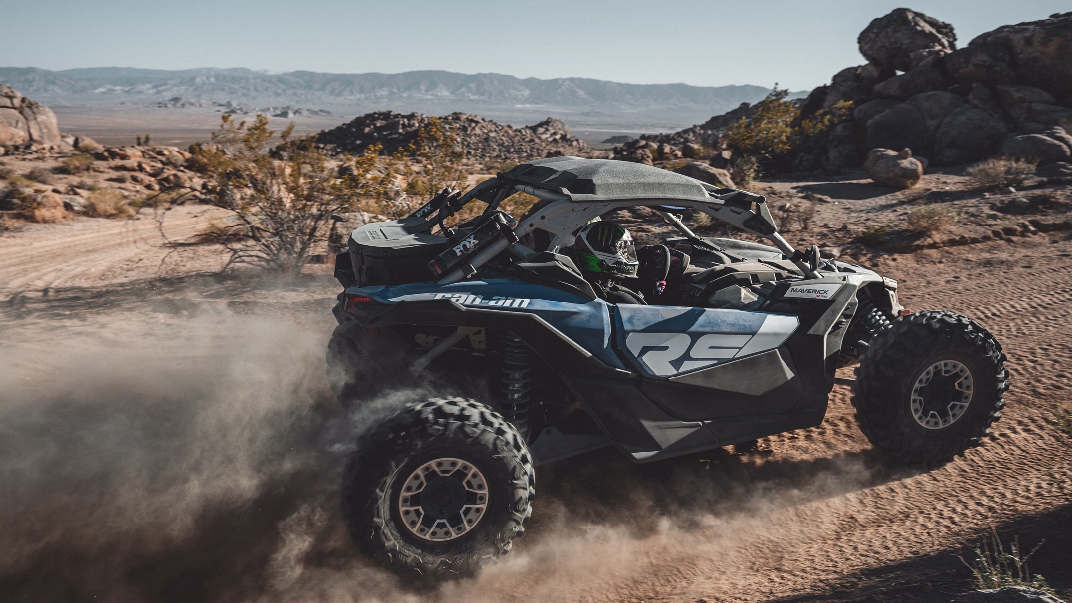 Man driving a Can-Am Maverick in the sand