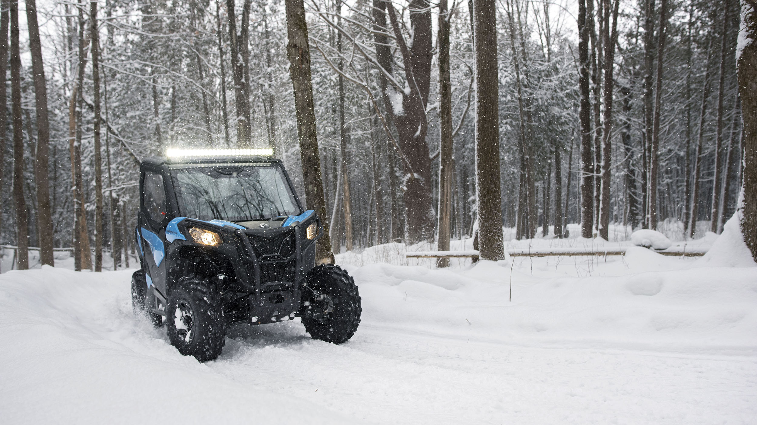 A Can-Am Maverick Trail turning in snow