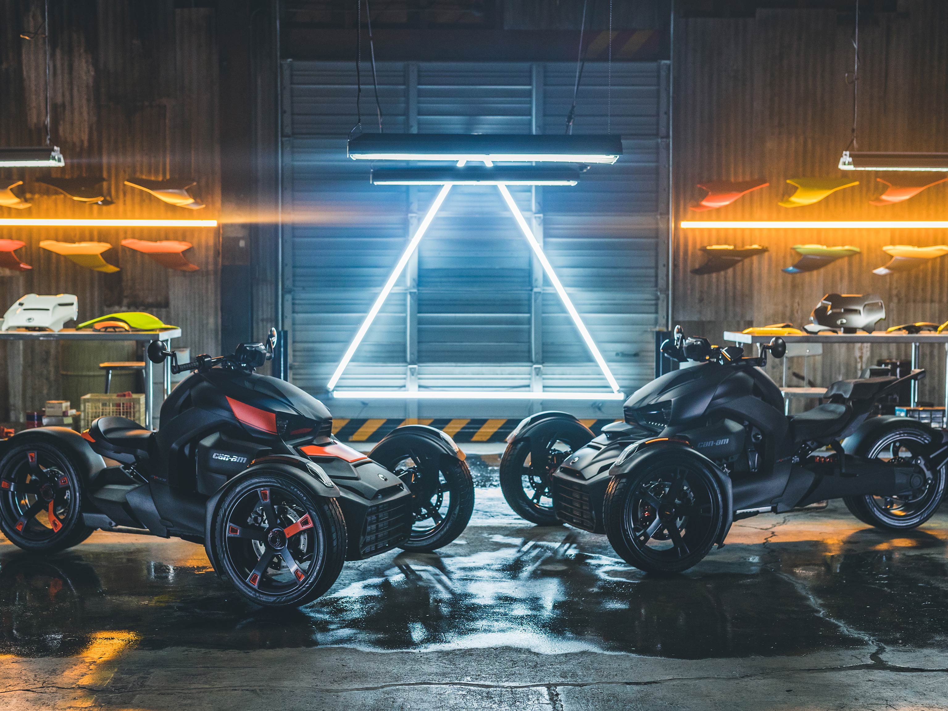 Pair of Ryker vehicles in a garage