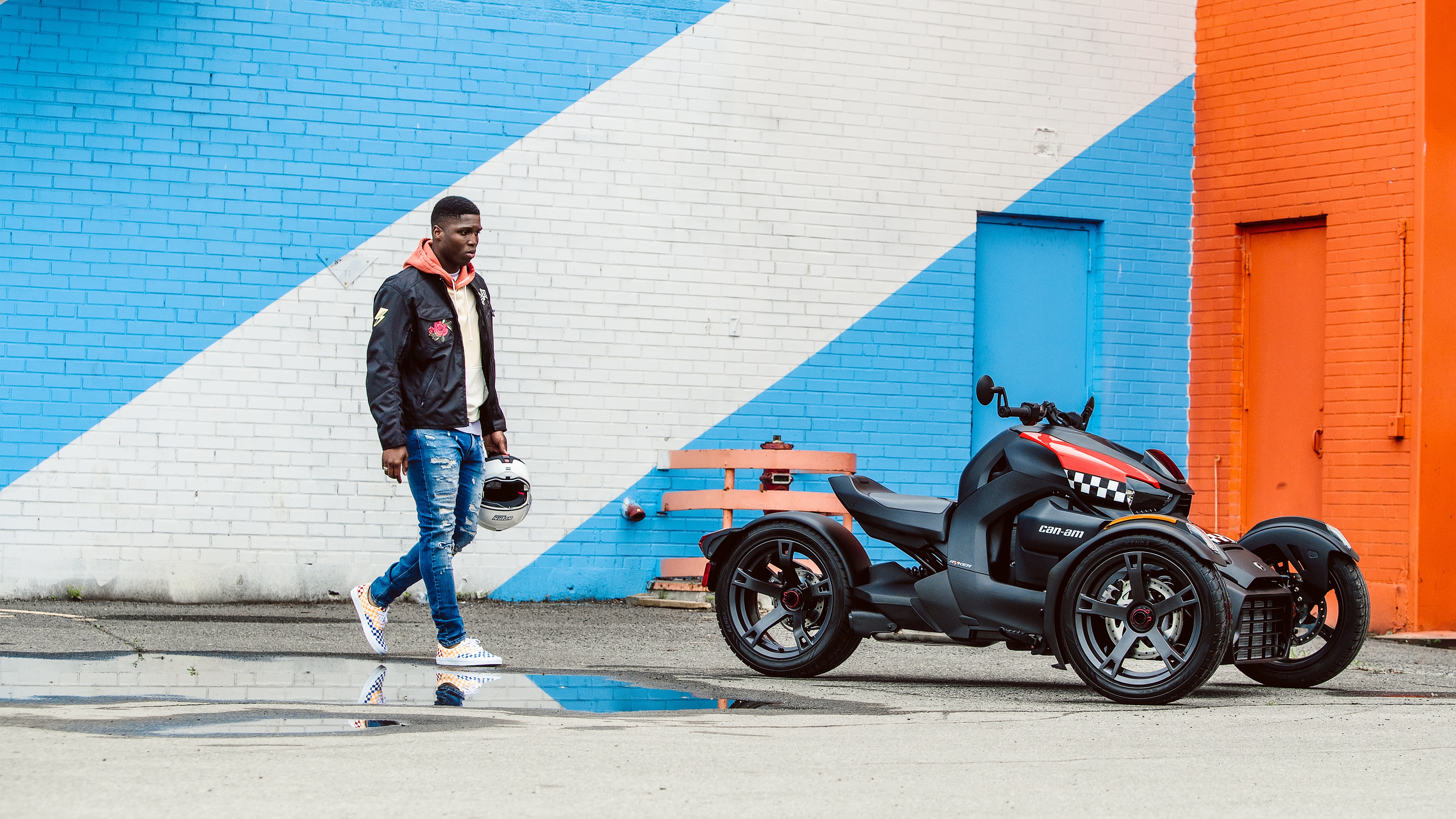 Man walking toward his Can-Am Ryker vehicle