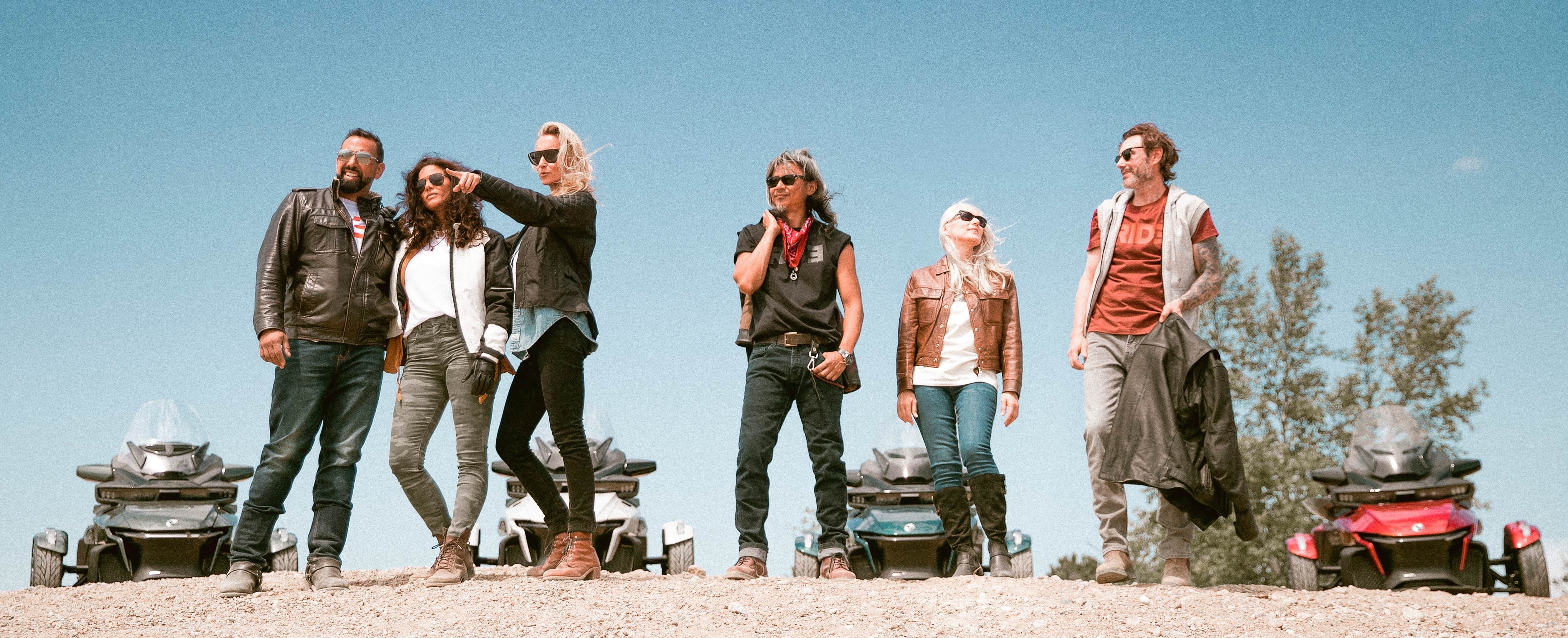 Six friends near their Spyder vehicles