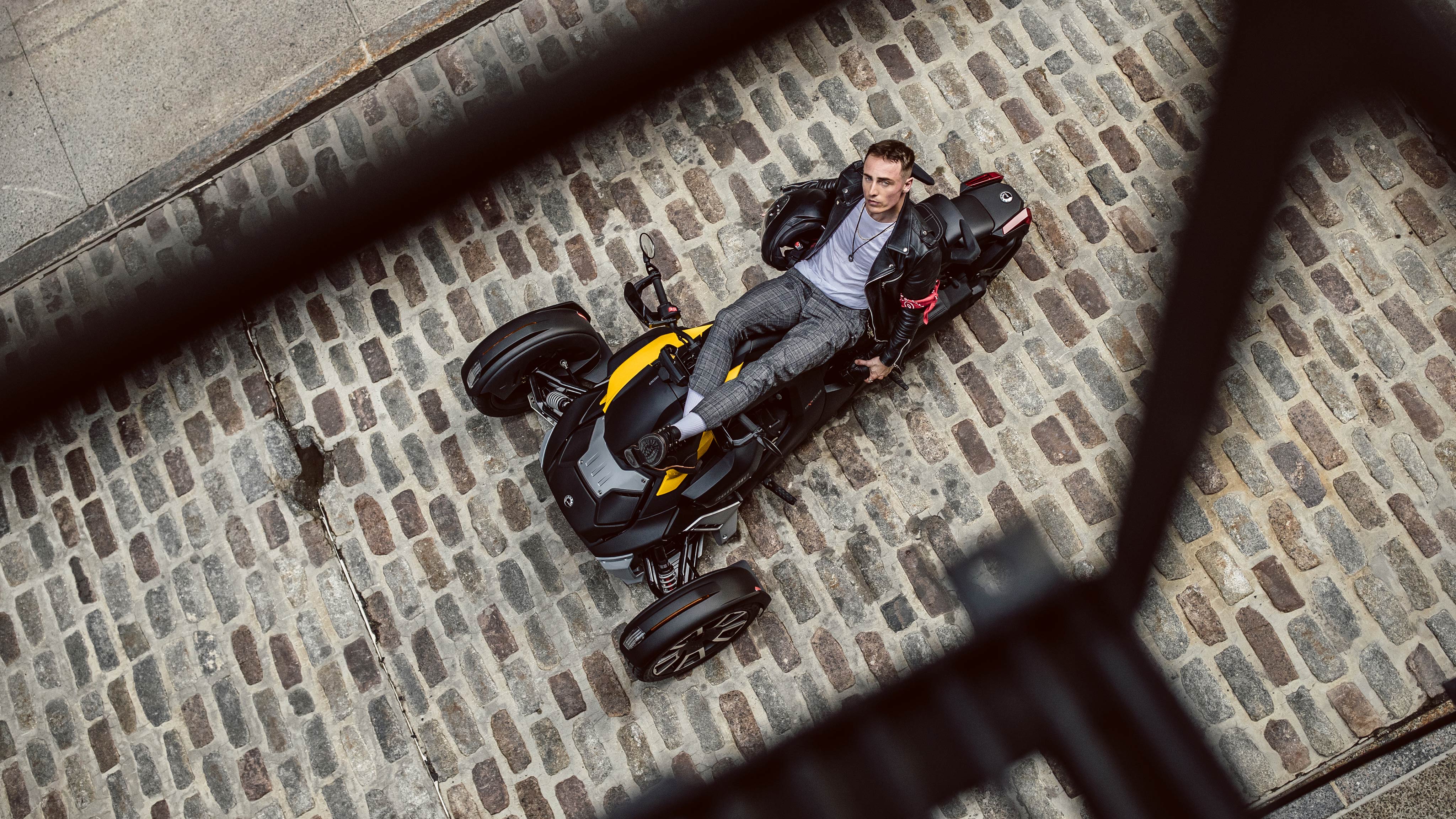 Man seated in his Ryker and looking up