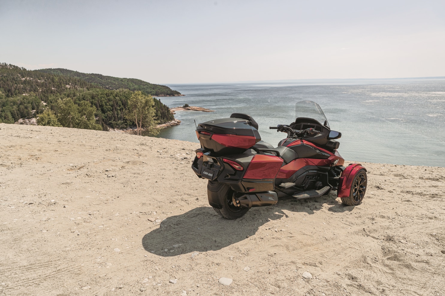 Spyder RT on sand, near a cliff and water