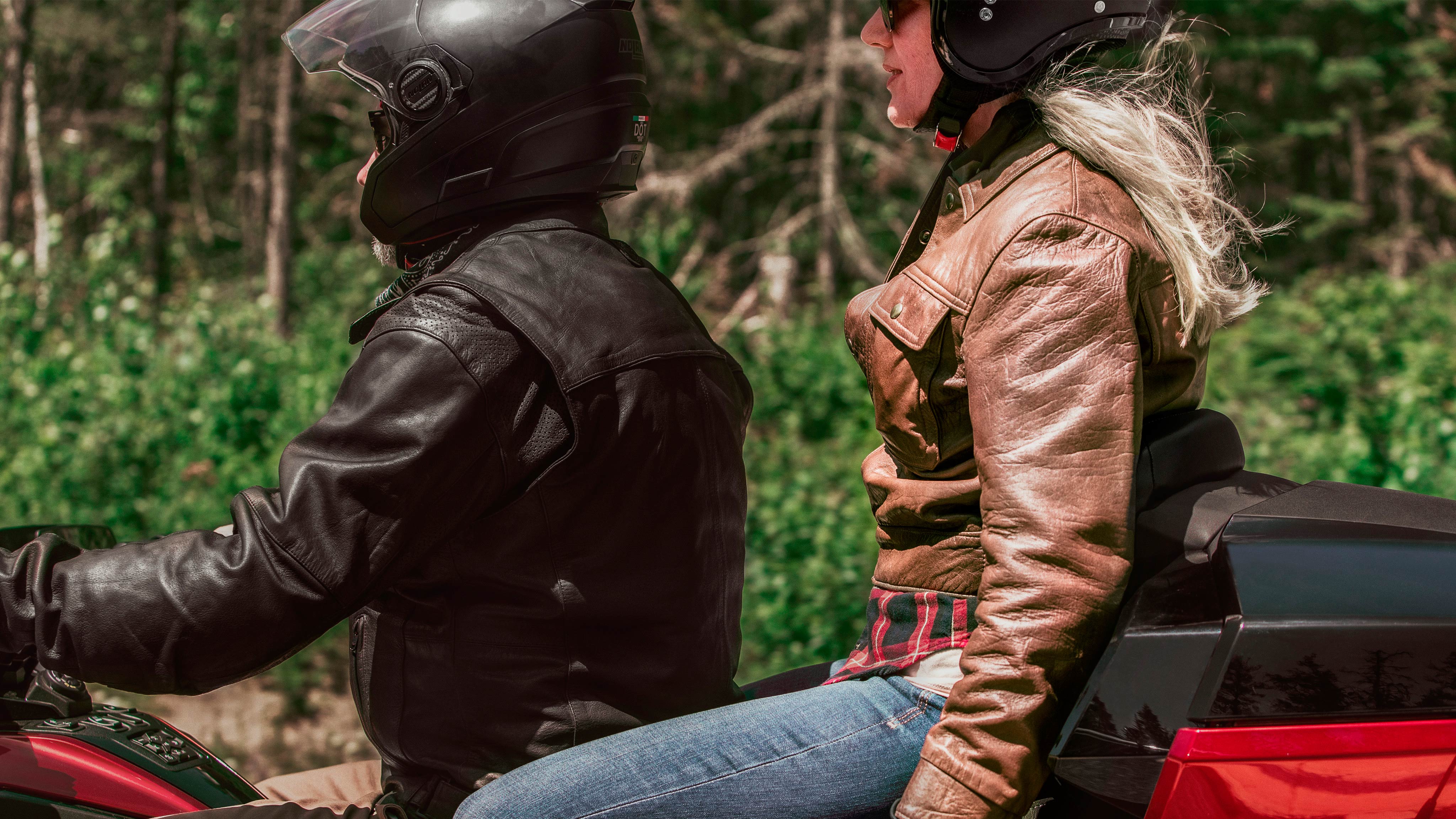 Couple sitting on Can-Am Spyder RT vehicle